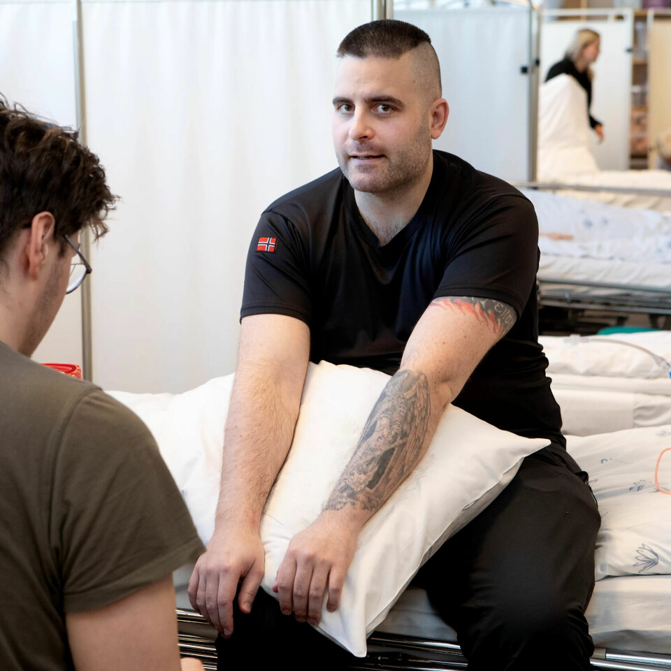 Øver: Helsefarbeider Robert Husum har øvd seg på å sette kanyle, nå er han «pasient»for en medstudent på piloten «medisinske prosedyrer». . Øver: Helsefarbeider Robert Husum har øvd seg på å sette kanyle, nå er han «pasient»for en medstudent på piloten «medisinske prosedyrer». .